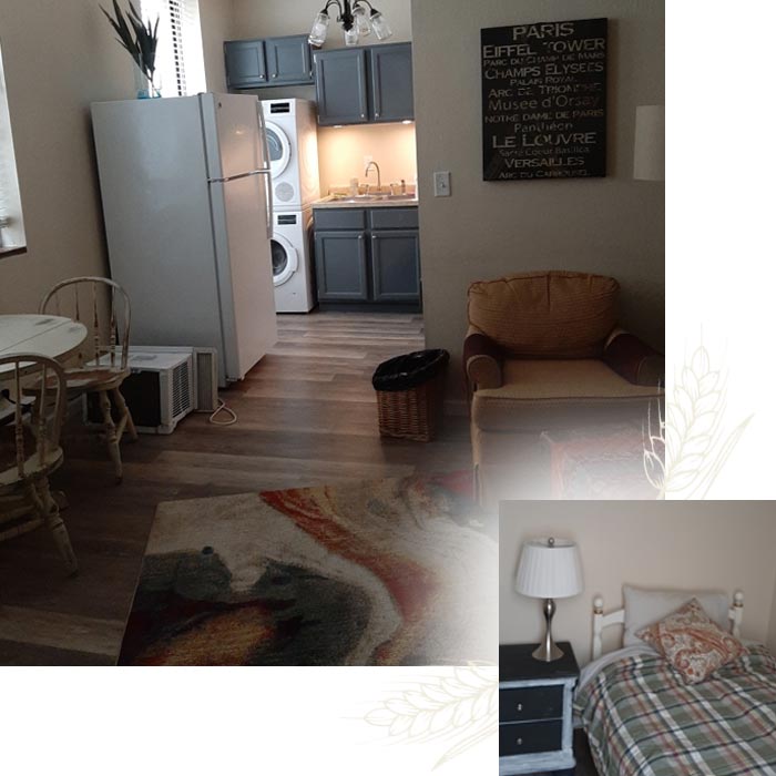 Small apartment with kitchen, dining table, laundry, armchair, and bakery-inspired décor.