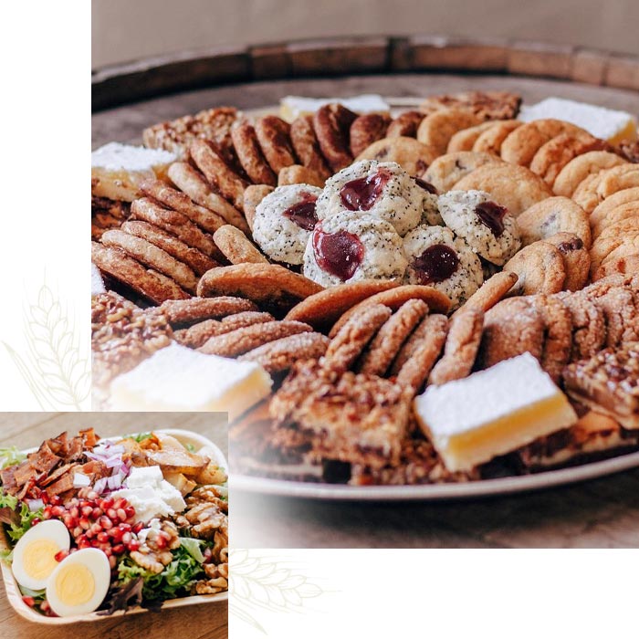 A platter of assorted cookies and bars from Nichole's Fine Pastry, plus a salad with eggs and pomegranate.